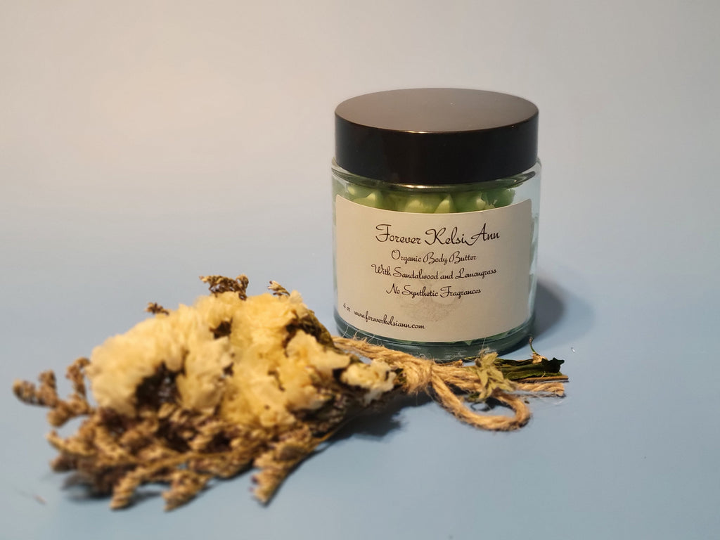 Jar of Forever Kelsi Ann organic Sandalwood and Lemongrass body butter with a decorative rope and natural elements on a light background