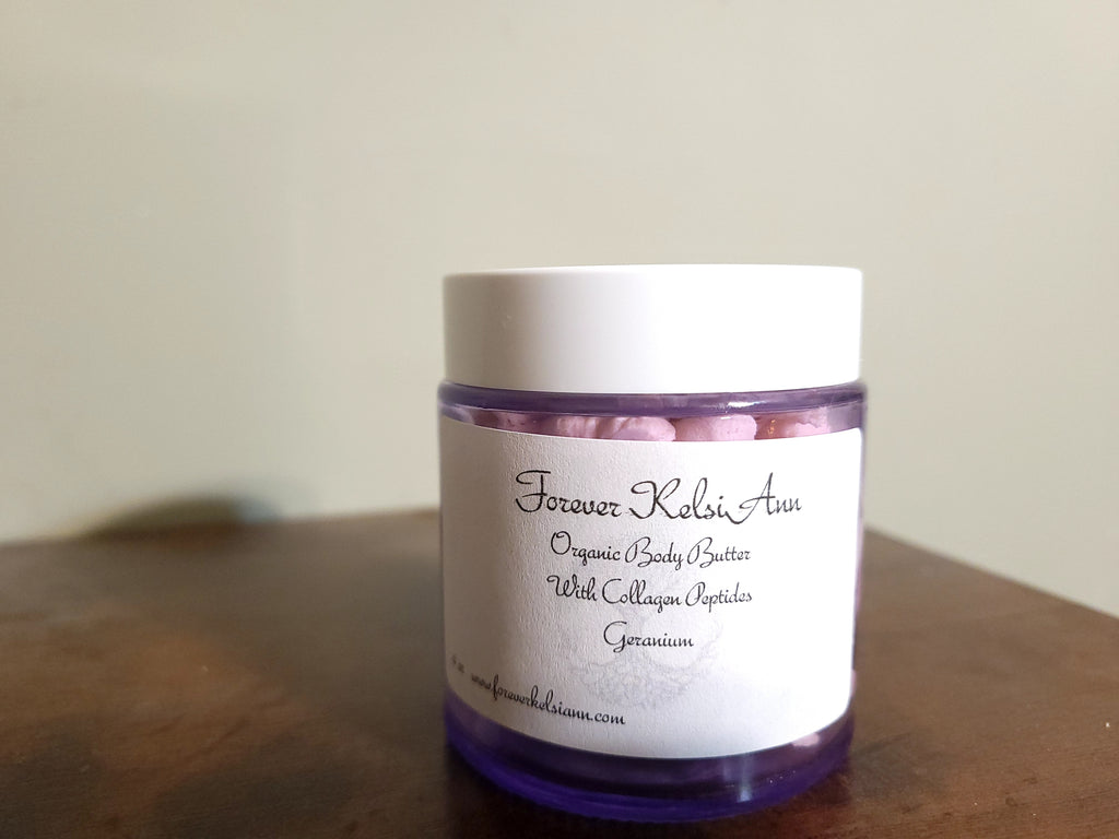 Jar of Forever Kelsi Ann organic body butter on a wooden surface with a plain background
